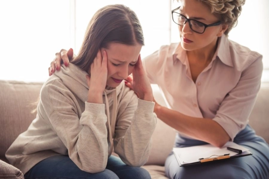 Psychologist supports a woman in distress during therapy session
