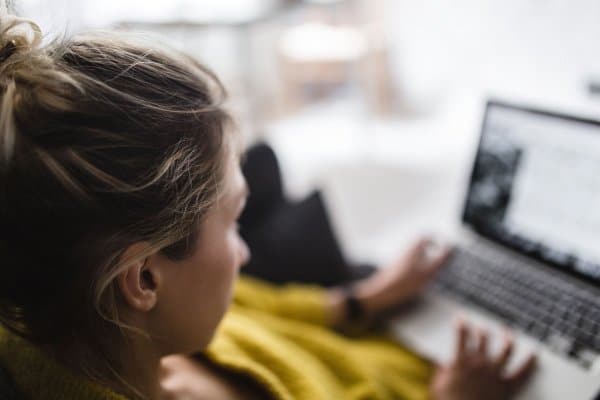 Woman in front of laptop sitting on the couch